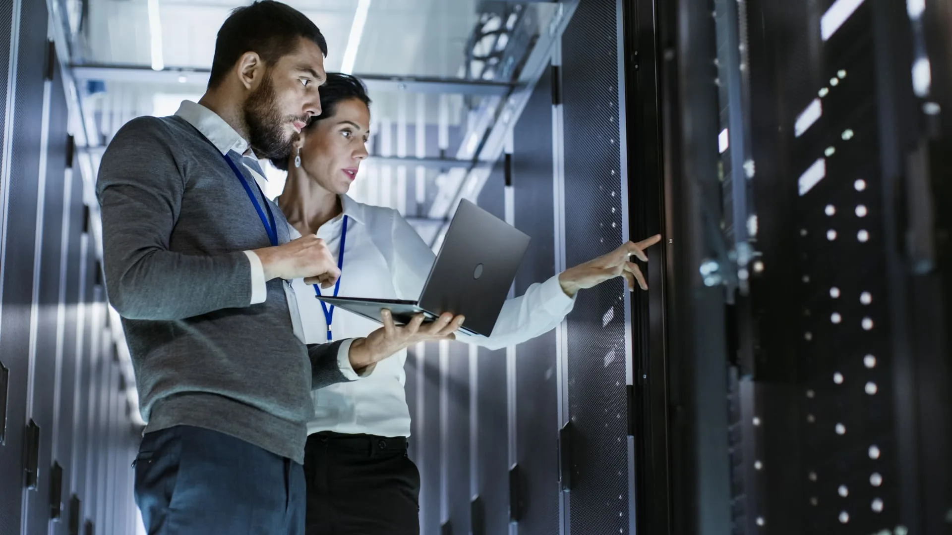 Two engineers working at a server rack